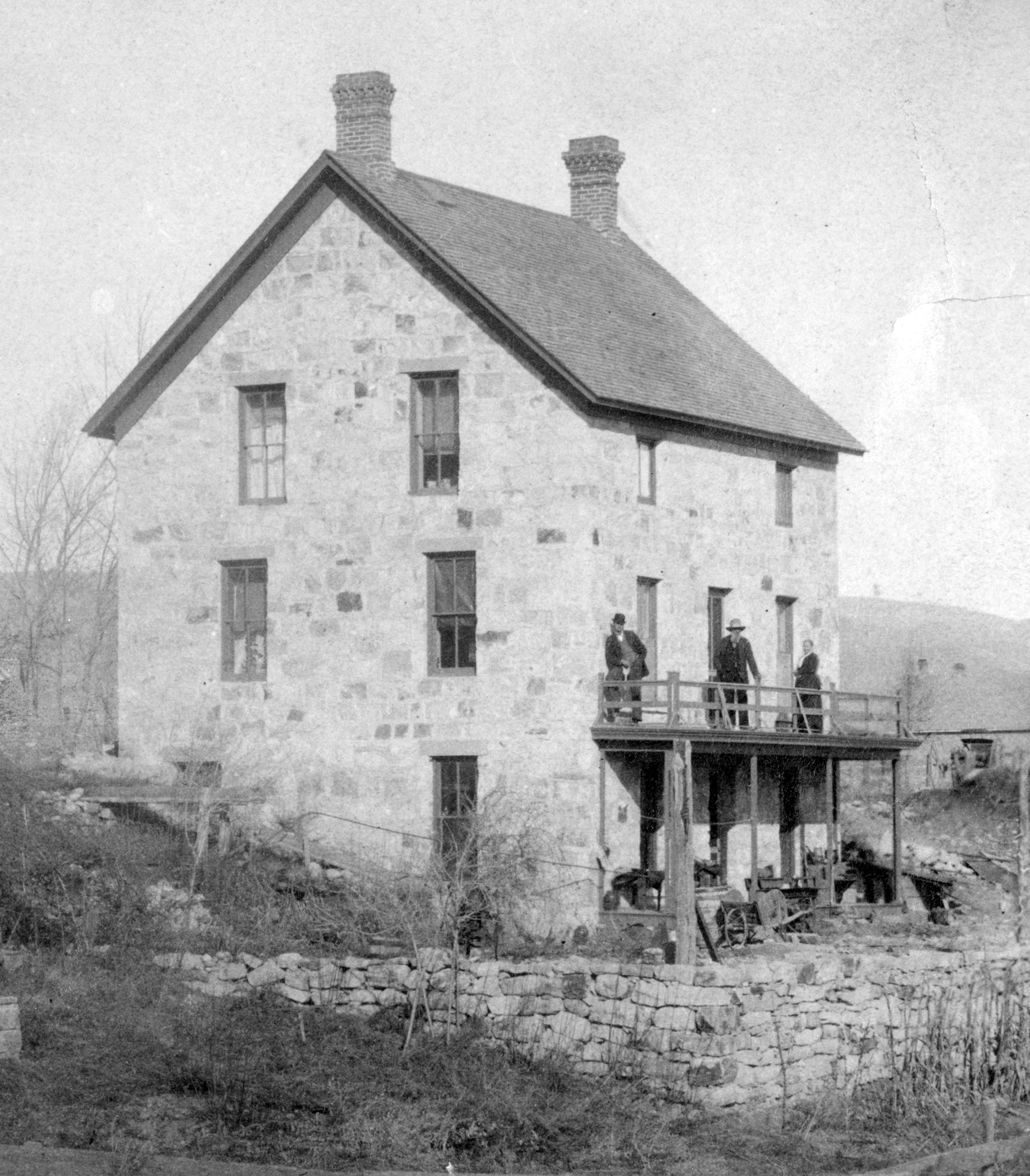 Black and white photo of Anson Rudd stone house that was built in 1881. Photo circa 1890.