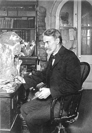 Black and white image of Edward Drinker Cope sitting at a desk.