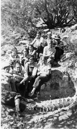 Black and white image of Kessler's students posing with unearthed dinosaur vertebrae. Circa 1932.