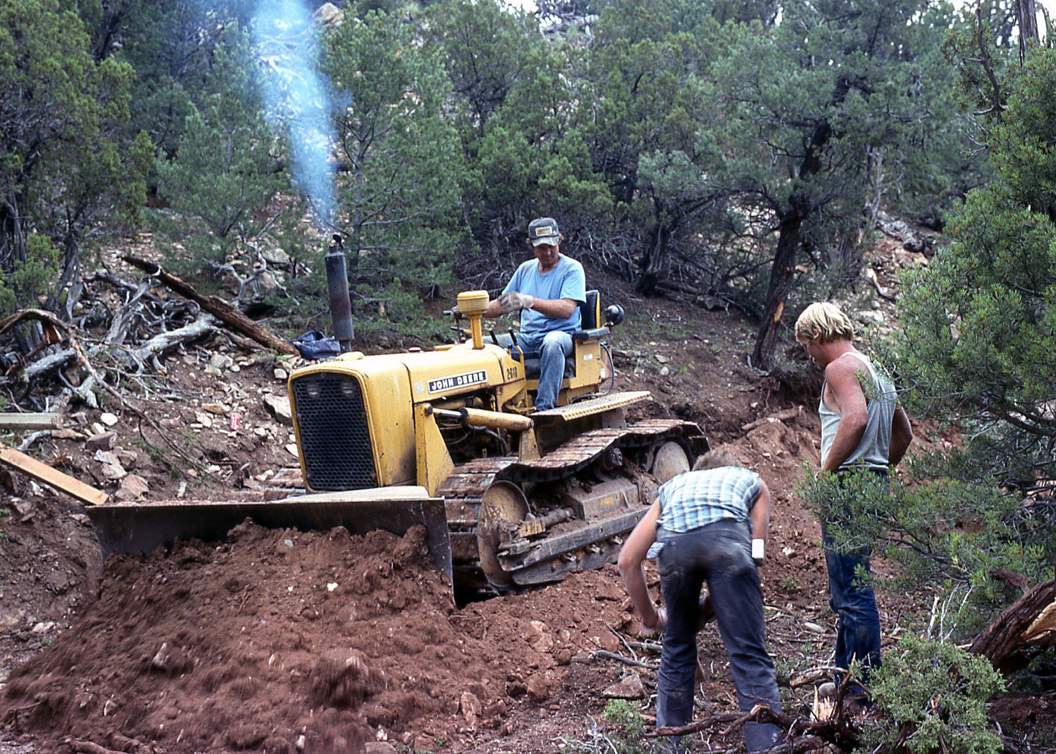 Color photo of a person on a bulldozer at the quarry site. Circa 1992.