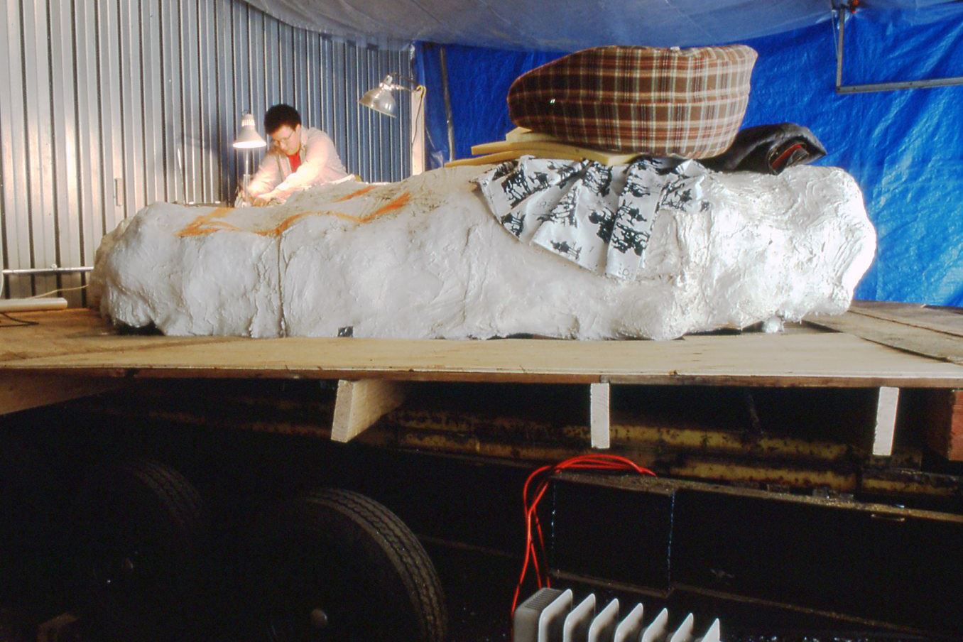 Color photo of jacketed stegosaurus fossil on a table. Circa 1992.