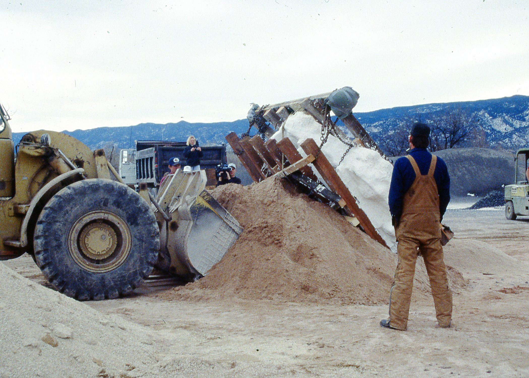 Color photo of people preparing to move the jacketed stegosaurus fossil. Circa 1992.